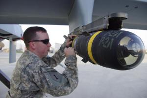 Signing a Hellfire missile attached to a MQ1-C (Gray Eagle) UAV at Bagram