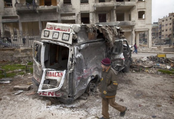 A Syrian youth walks past a destroyed ambulance in the Saif al-Dawla district of the war-torn northern city of Aleppo on January 12, 2013. An accident and emergency centre in Aleppo uses an abandoned supermarket to conceal a fleet of 16 ambulances, just 10 of which are in working order and are driven by 22 staff members. AFP PHOTO/JM LOPEZ/ (Getty Images)